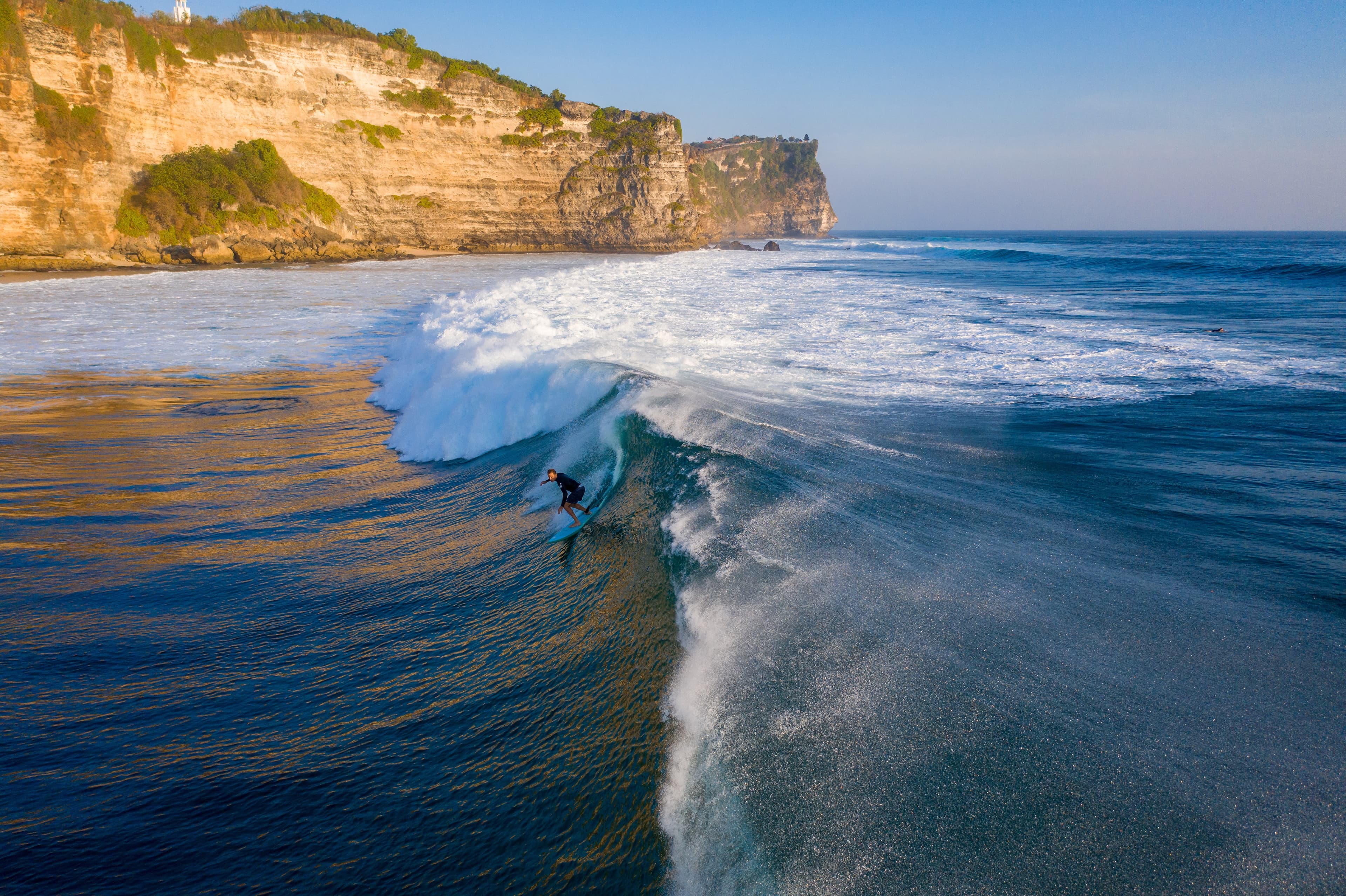 Glowing canyon walls with layered textures under sunset light